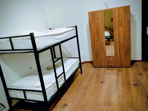 a room with two bunk beds and a wooden floor at GuestHouse3 Karma369 in Plovdiv