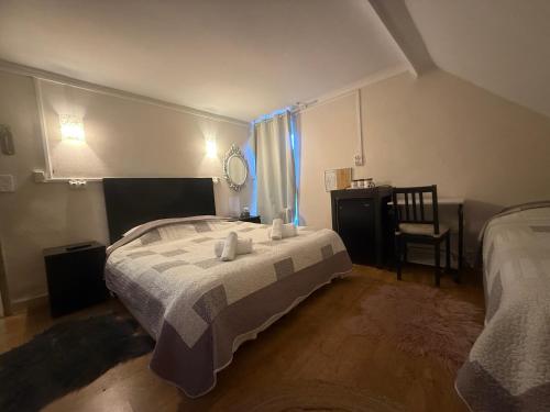 a bedroom with two beds and a table and a chair at Auberge aux 1000 saveurs in Malay-le-Petit