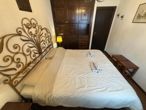 a bedroom with a large bed with white sheets at Neve 5 Apartment - Clotes Slope Access in Sauze d'Oulx