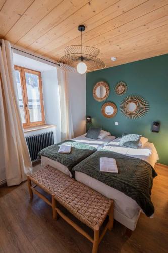 a bedroom with two beds and a wooden ceiling at Gite Le Rebanchon in Le Monêtier-les-Bains