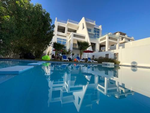 a swimming pool in front of a house at White House Boutique Sharm in Banī Ghālib