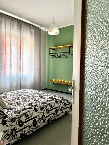 a bedroom with a bed and a green wall at Fuori Arena in Casalecchio di Reno