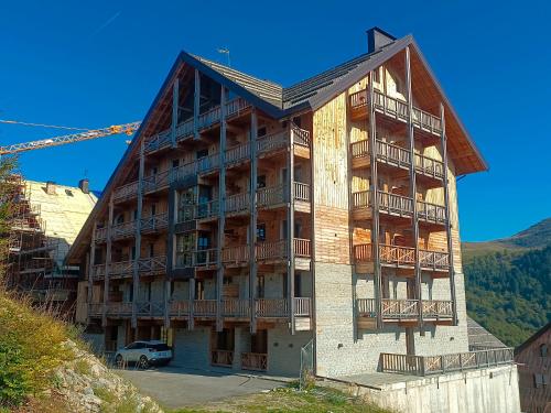 a large building with balconies on the side of it at Borgo Stalle in Prato Nevoso