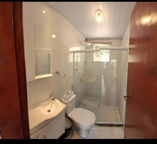 a bathroom with a toilet and a sink and a shower at Suíte Atobás in Arraial do Cabo