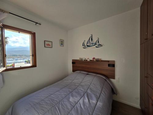 a bedroom with a bed and a window at T2 cosy et rénové avec vue sur le port d'Argelès pour 4 personnes in Argelès-sur-Mer