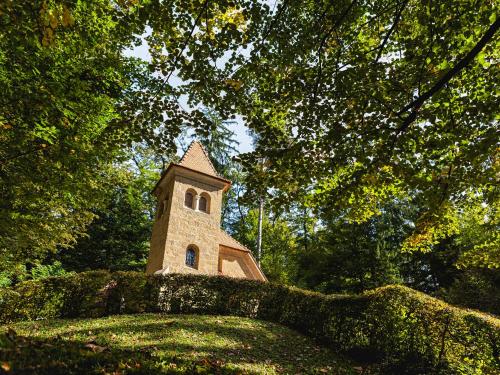 a small tower on top of a hill with trees at Atlantida Boutique Hotel in Rogaška Slatina