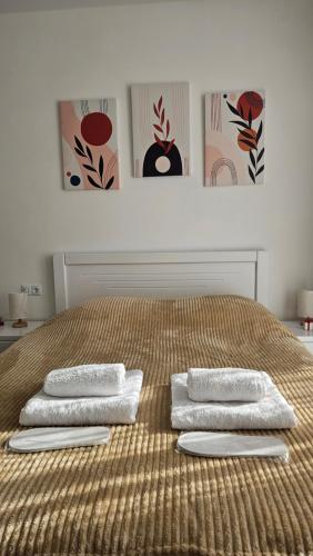 a bed with three towels on top of it at Bakuriani Cozy Studio in Bakuriani