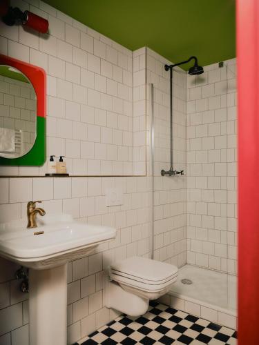 a bathroom with a sink and a toilet and a shower at The Dean Berlin in Berlin