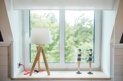 two dolls in a room with a window at Willa Błękit Hotel by Dorota Szelągowska in Mielno
