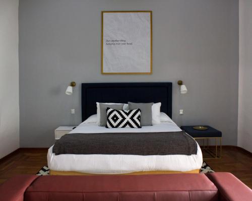 a bedroom with a large bed with a black headboard at Markee Hotel Boutique in Querétaro