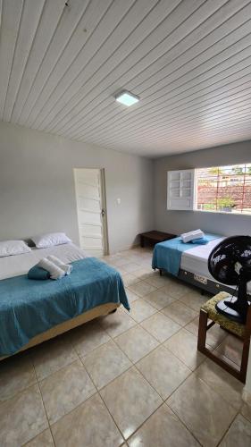 a bedroom with a bed and a table in it at GRA325 | Spacious Retreat with Pool and Barbecue. in Gravatá