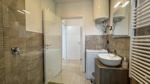 a bathroom with a sink and a toilet and a shower at La Cà - Casa Vacanze in Torre De' Roveri