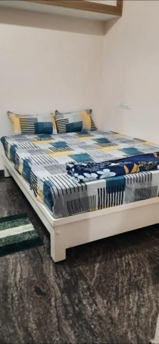 a large bed in a room with at Powerstar home stay in Hampi