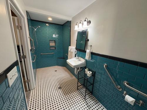 a bathroom with a sink and a shower at Historic Ziegler Inn and Suites with Whimsical Themed Rooms in New Bern