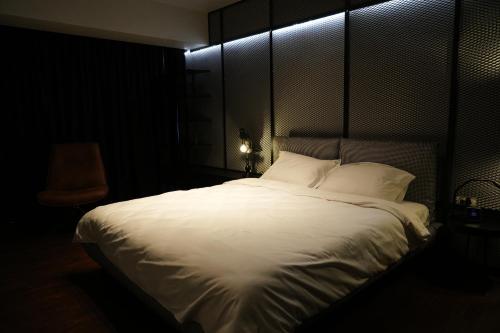 a bedroom with a large bed with white sheets and pillows at Flat 6 - Luxury Designer Apartment in Odăile