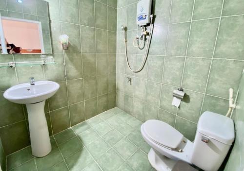 a bathroom with a toilet and a sink and a shower at Văn An Hotel in Ho Chi Minh City