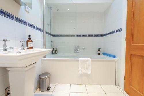 a white bathroom with a tub and a sink at 1 Bed in Linton oc-s31746 in Linton