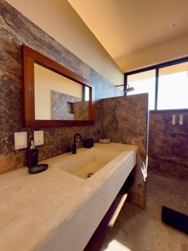 a bathroom with a large sink and a mirror at Luxury Ocean View Villa in Brisas de Zicatela