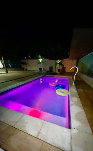 a swimming pool with a frisbee in it at night at House in Iriri in Anchieta