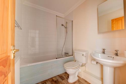 a bathroom with a toilet and a sink and a tub at 2 Bed in Southwold oc-scl in Reydon