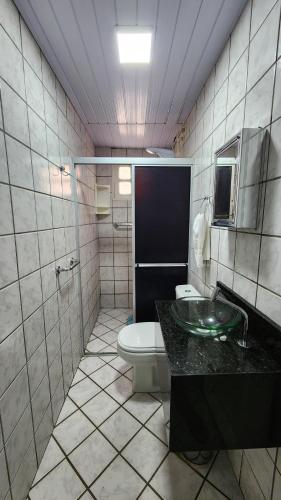a bathroom with a toilet and a sink at GRA325 | Spacious Retreat with Pool and Barbecue. in Gravatá