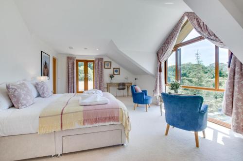 a bedroom with a bed and a large window at 7 Bed in Ashton oc-p00891 in Germoe