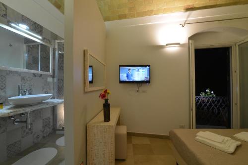 Televízia a/alebo spoločenská miestnosť v ubytovaní L'Affaccio Dell'Abate
