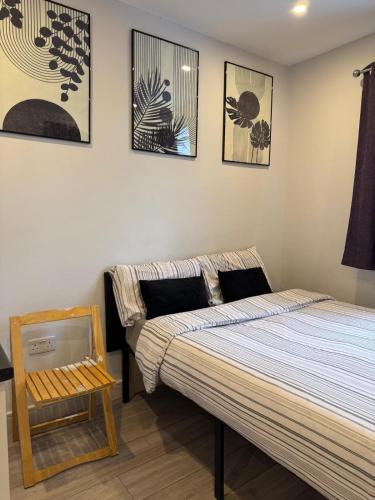 a bedroom with a bed and pictures on the wall at Brigstock 4 in Thornton Heath