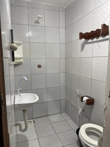 a bathroom with a sink and a toilet at Casa De Vó in Amontada
