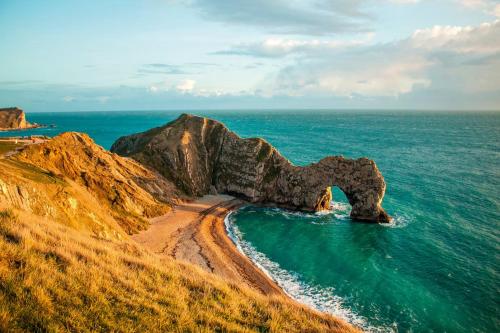 a rock formation in the ocean next to the ocean at Weymouth Bay Holiday Static Caravan in Preston