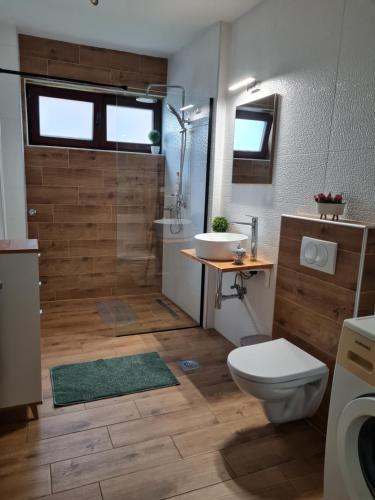a bathroom with a shower and a toilet and a sink at OLD TOWN ROAD in Karlovac
