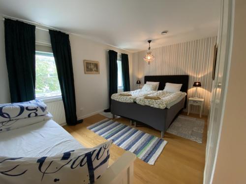 a bedroom with two beds and a window at Charming villa near the beach in Vejbystrand SE01066 in Vejbystrand