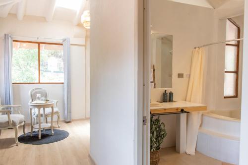 a bathroom with a sink and a tub and a table at Tariq Sacred Valley in Urubamba