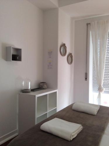 a white room with two white pillows on a bed at 4U Lisbon IV Guesthouse Airport in Lisbon