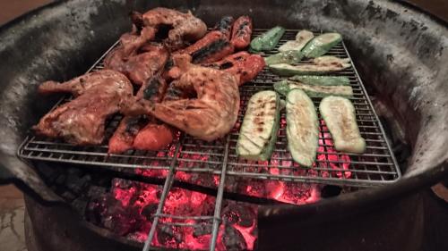 a bunch of meat and vegetables on a grill at Jungle Palace hostel santaella in Puerto Escondido