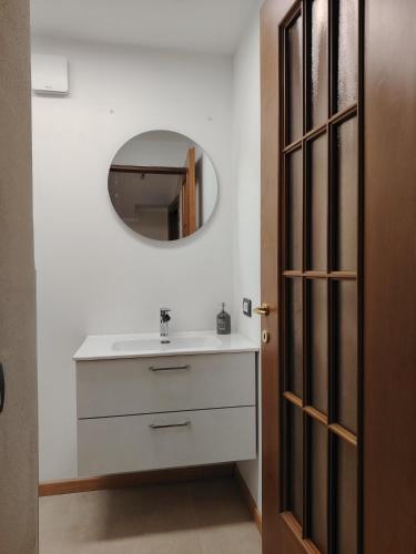a bathroom with a white sink and a mirror at Appartamento Mara in Domodossola