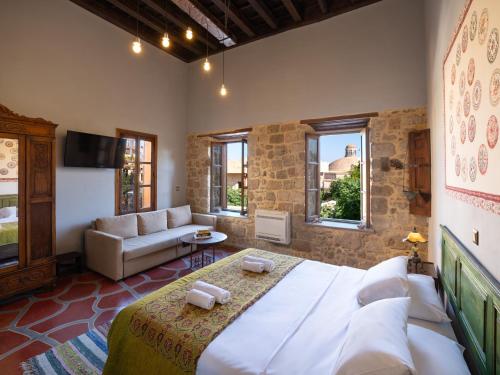 a bedroom with a large bed and a couch at Colours - Old Town - Studios in Rhodes Town