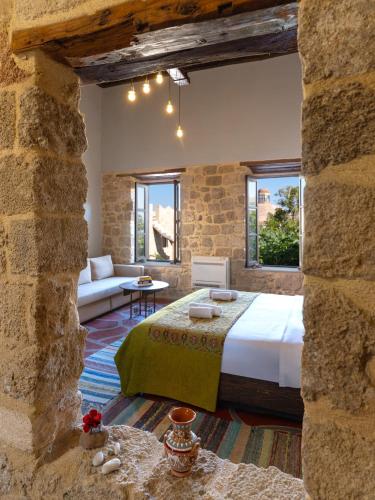 a bedroom with a bed and a couch in a room at Colours - Old Town - Studios in Rhodes Town