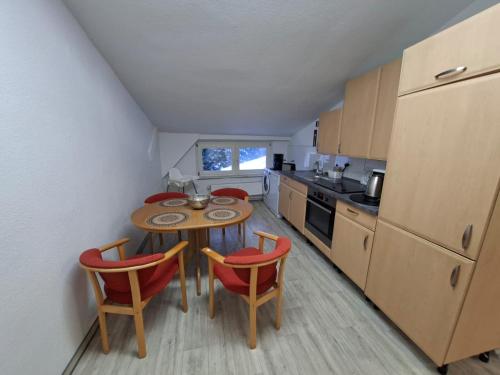a kitchen with a table and two chairs and a table at FeWo im Herzen Tarnows in Tarnow
