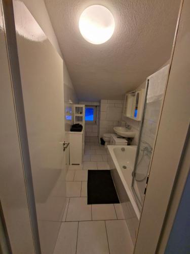 a bathroom with a tub and a toilet and a sink at FeWo im Herzen Tarnows in Tarnow