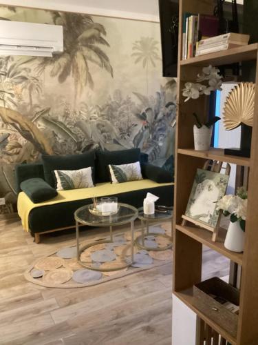 a living room with a couch and a table at Guest house arboré in Saint-Loubès
