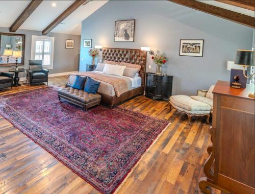 a bedroom with a bed and a living room at Whispering Prairie Lodge in Salina