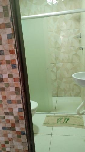a bathroom with a shower and a sink at Aconchego em Peroba in Maragogi