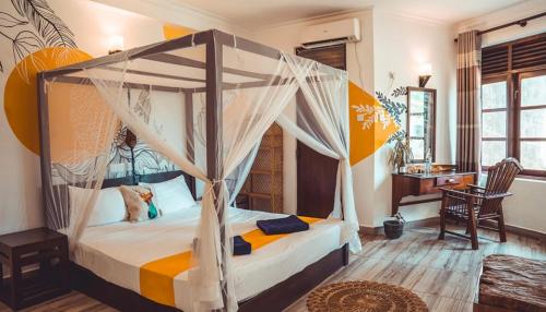 a bedroom with a bed with a canopy at Dickwella Beach in Dickwella