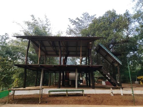 a play structure with a bench in a park at Mur Farm House in Sonāpur