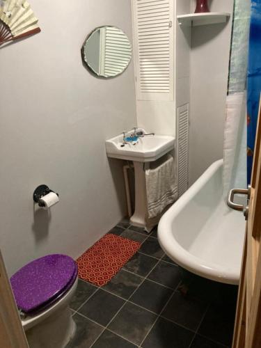 a bathroom with a sink and a toilet and a tub at Step-free modern central apartment in Todmorden