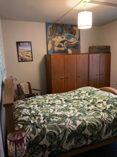 a bedroom with a bed and a painting on the wall at Step-free modern central apartment in Todmorden