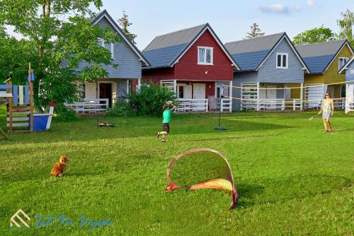a group of children playing in a yard with a kite at LATO NA WYSPIE in Gdańsk