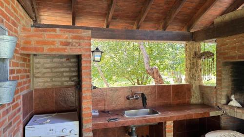 a kitchen with a sink and a window at Encantos del Bosque in Colón