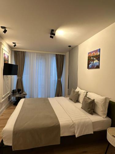 a bedroom with a large bed in a room at House4You - Praporgescu in Bucharest